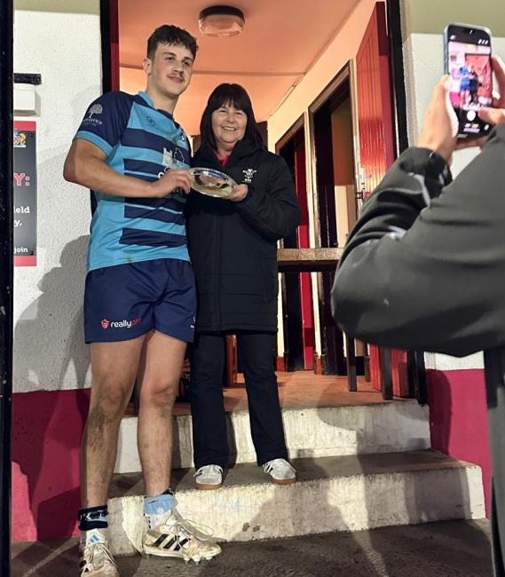 Aber captain Henry Michell receives the runners-up trophy from Delyth Summons
